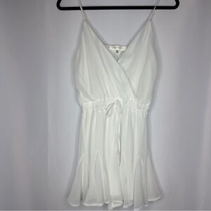 Nordstrom Row•A white lined v-neck bow tie romper. Adjustable straps